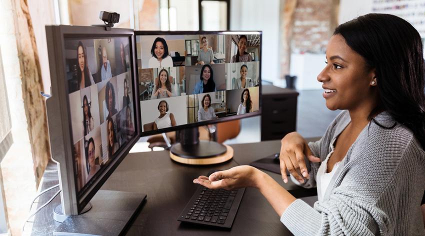 During COVID-19, a woman gestures during virtual meeting with colleagues